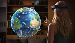 Microsoft HoloLens user interacting with a holographic globe.