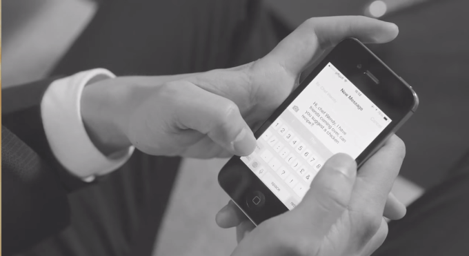 Man inputting text on his smartphone.