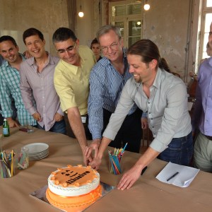 Eric Schmidt and Illusive Networks founders cut a cake at company headquarters in Israel.