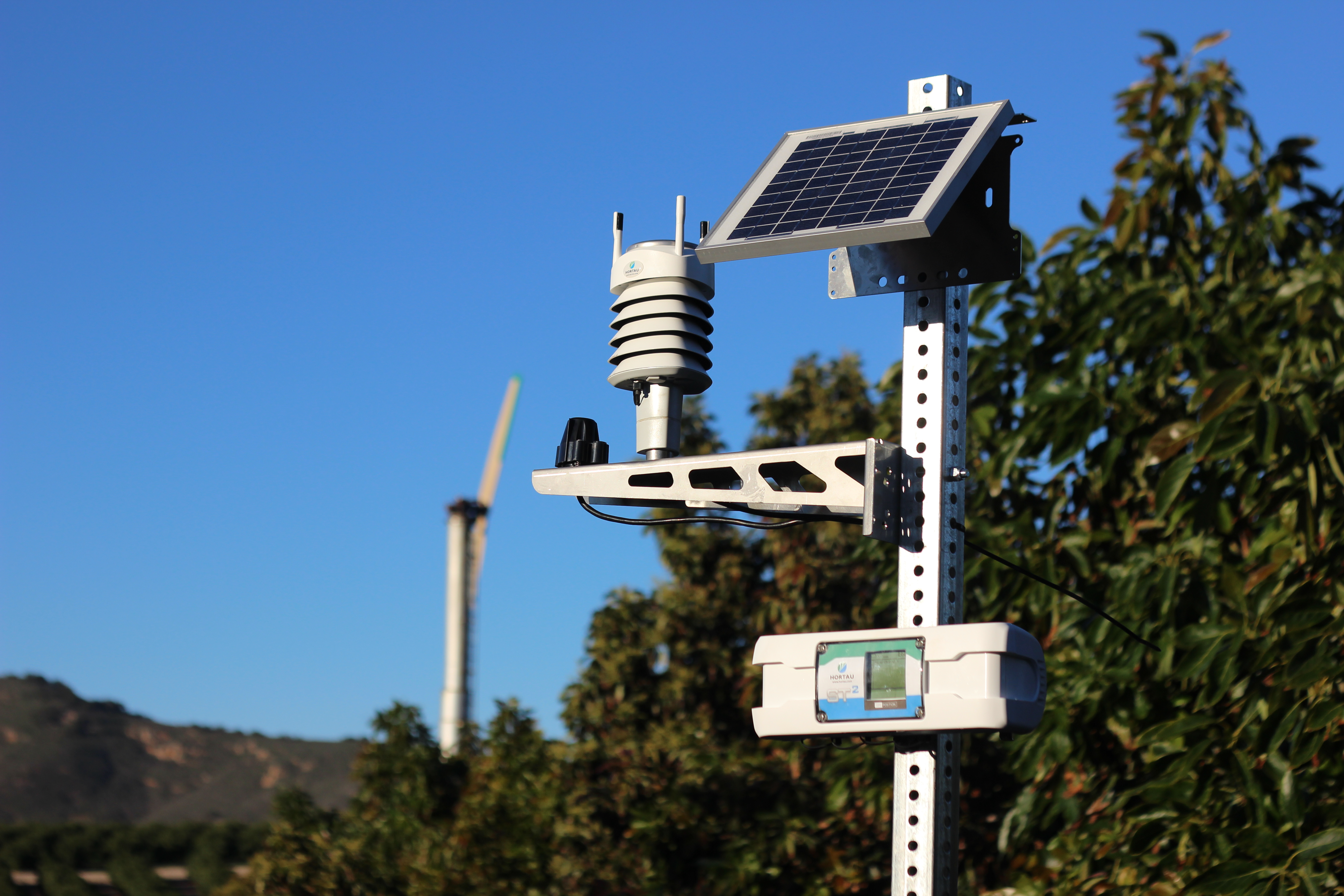 solar-powered-weather-station-fan-jets-in-background