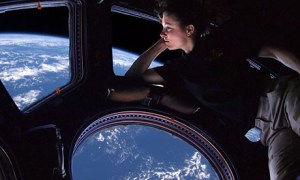Astronaut Cady Coleman looking out window of the International Space Station / Image courtesy of NASA