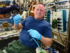 Astronaut Barry Wilmore with a 3D printed ratchet / Image courtesy of NASA