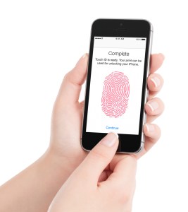 Finger completing Touch ID on iPhone.