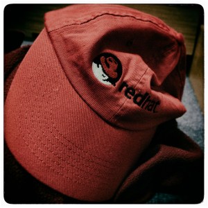 Crumpled cap with Red Hat logo on it.