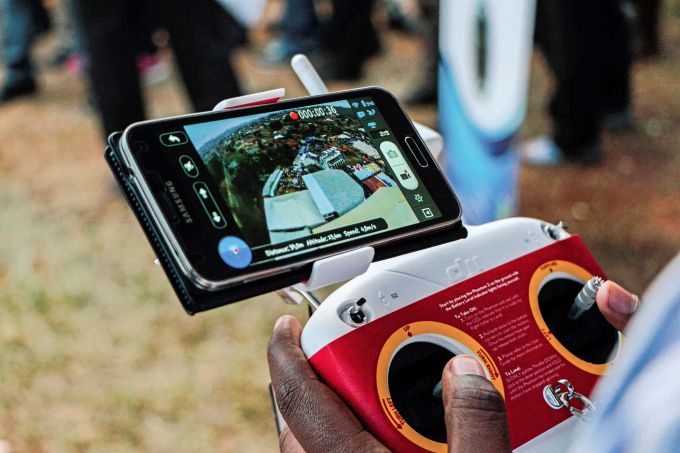 A photo taken on July 24, 2014 shows an aerial view displayed on a mobile phone synchronised to a tele-guided drone camera during an international trade fair in Kigali. Rwanda is planning to construct a droneport in order to get drones to carry mostly medical urgent supplies from a central hub to rural areas around the country. (Photo: CYRIL NDEGEYA/AFP/Getty Images)