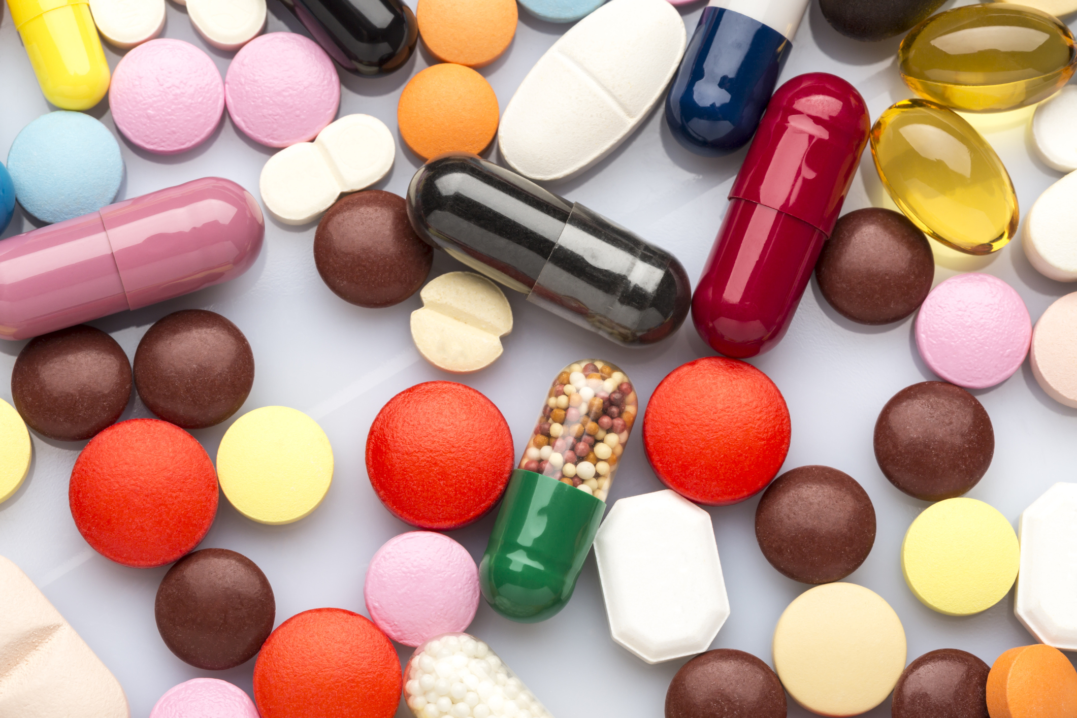 Scattered colorful medical pills and capsules