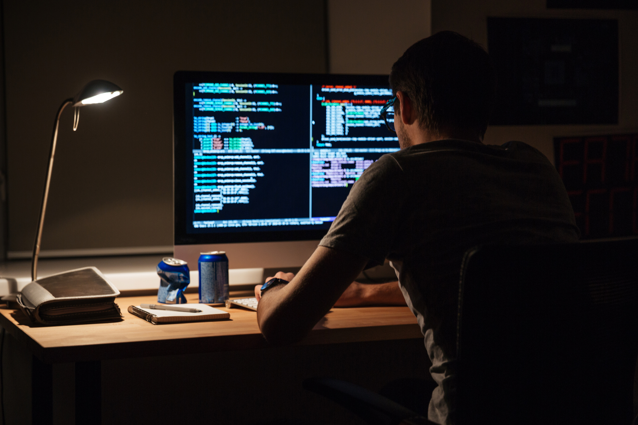 Man coding on computer at night.