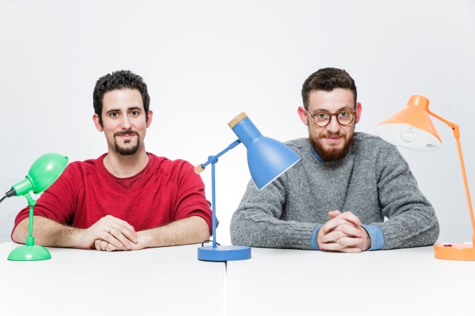 Signal Media's two founders and three desk lamps