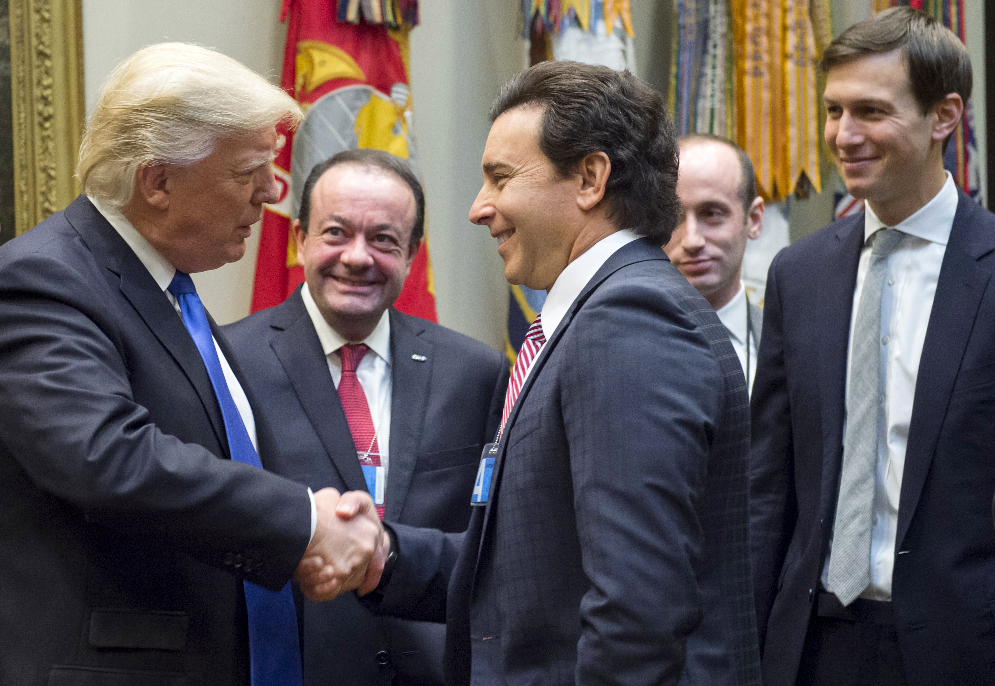 US President Donald Trump greets Ford President and CEO Mark Fields (C) prior to a meeting with automobile industry leaders in the Roosevelt Room of the White House in Washington, DC, January 24, 2017. (Photo: SAUL LOEB/AFP/Getty Images)